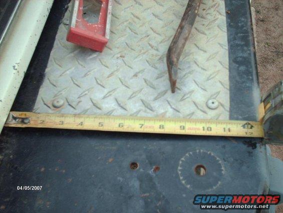 Tape measure, crowbar, and red tool on diamond plate. Date stamp 04/05/2007