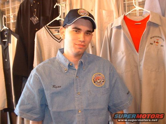 Man in denim shirt with Ryan embroidered on it, and a patch on the chest