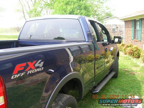 Dark blue 2004 Ford F-150 FX4 Off Road pickup truck, rear quarter view