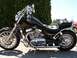 1979 Ford F-150 - A black motorcycle with chrome details is parked outdoors on a sunny day.