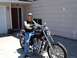 1979 Ford F-150 - Man on a black motorcycle parked in front of a house.