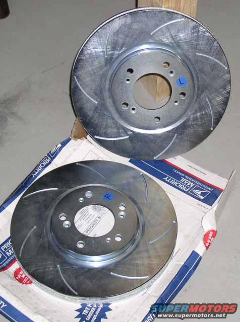 Two slotted brake rotors on a USPS Priority Mail box
