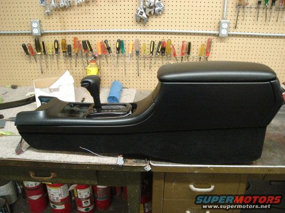 Car's center console and gear shifter assembly on a workbench