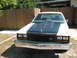 1985 Ford Crown Victoria LTD - Front view of a 1985 Ford Crown Victoria LTD with a prominent hood scoop and dark grille.