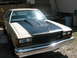 1985 Ford Crown Victoria LTD - This 1985 Ford Crown Victoria LTD features a prominent aftermarket hood scoop on its dark hood.