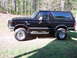 1989 Ford Bronco - This black 1989 Ford Bronco is shown with a lifted suspension and large off-road tires.