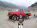 1970 Mercury Cougar - A red lifted Ford Bronco from the 1980s is parked in a dry, dusty area with a boy standing in front.