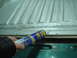1996 Ford Bronco - Seam sealer applied to a ribbed metal surface.