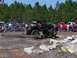1989 Ford Bronco - An off-road vehicle navigates an obstacle course with spectators gathered around.
