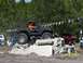1989 Ford Bronco - An off-road SUV navigates a challenging obstacle course, with spectators watching in the background.