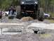 1989 Ford Bronco - Off-road vehicle navigates a challenging obstacle course with spectators watching.