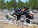 1989 Ford Bronco - An off-road SUV tackles a challenging obstacle course with spectators watching.