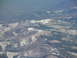 1995 Ford C-350 (Centurion Conversions) - A vast expanse of mountains shows patches of snow and scattered evergreen trees.