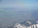 1995 Ford C-350 (Centurion Conversions) - An aerial view captures a vast valley dotted with buildings, bordered by mountains and a distant lake.