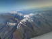 1995 Ford C-350 (Centurion Conversions) - Aerial view of vast mountain ranges with snow on their peaks under a clear blue sky.