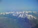 1995 Ford C-350 (Centurion Conversions) - Expansive mountain landscape seen from above, with snow-covered summits under a clear sky.