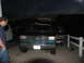 1995 Ford C-350 (Centurion Conversions) - A dark blue and teal Ford F-Series truck is parked in a driveway at dusk, with a person in the driver's seat.