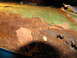 1995 Ford C-350 (Centurion Conversions) - This heavily rusted metal surface shows significant paint peeling, indicating severe corrosion.