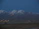 1995 Ford C-350 (Centurion Conversions) - Streaking lights blur across the landscape with mountains in the background at dusk.