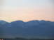 1995 Ford C-350 (Centurion Conversions) - A blurry mountain range is visible against a soft pink and white sky during twilight.
