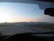 1995 Ford C-350 (Centurion Conversions) - Driving on a highway towards a mountain range during a colorful sunset, seen from inside the vehicle.