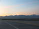 1995 Ford C-350 (Centurion Conversions) - Driving on a highway with a mountain range visible at sunset.