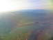 1995 Ford C-350 (Centurion Conversions) - Expansive aerial view showing mountains, a lake, and surrounding terrain under a bright sky.