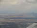 1995 Ford C-350 (Centurion Conversions) - An aerial view captures a city skyline along a coastline, with clouds overhead.