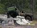 1989 Ford Bronco - Two off-road vehicles tackle a challenging obstacle course made of concrete barriers.
