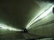 1995 Ford C-350 (Centurion Conversions) - Driving through a tunnel with lights lining the walls and ceiling.
