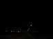 1995 Ford C-350 (Centurion Conversions) - View from a vehicle traveling on a highway at night, with lights visible in the distance.