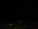 1995 Ford C-350 (Centurion Conversions) - Blurry orange lights streak across a dark scene, suggesting motion at night.