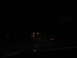 1995 Ford C-350 (Centurion Conversions) - View from inside a vehicle driving on a dark road at night with distant lights visible.