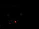 1995 Ford C-350 (Centurion Conversions) - A dark scene shows two signs and two red lights, possibly traffic signals.