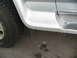 1995 Ford C-350 (Centurion Conversions) - Icicles hang from the side panel of a vehicle near the tire.