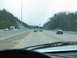 1995 Ford C-350 (Centurion Conversions) - A view from the driver's seat shows a highway with several cars and an RV traveling in the same direction.