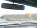 1995 Ford C-350 (Centurion Conversions) - View from inside a vehicle on a highway with a lake and trees visible.