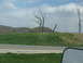 1995 Ford C-350 (Centurion Conversions) - A view of dead trees and hills from the side of the road.