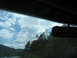 1995 Ford C-350 (Centurion Conversions) - View from inside a vehicle, looking out at a cloudy sky and trees.