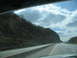 1995 Ford C-350 (Centurion Conversions) - Driving on a highway with trees lining the road under a cloudy sky.