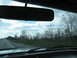 1995 Ford C-350 (Centurion Conversions) - Driving down the highway with a view of trees and clouds.