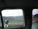 1995 Ford C-350 (Centurion Conversions) - Looking out the window at a scenic view of rolling hills and a valley below.