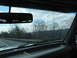 1995 Ford C-350 (Centurion Conversions) - View from inside a vehicle traveling on a highway, showing the dashboard, windshield, and the passing scenery.