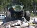 1989 Ford Bronco - A modified off-road vehicle tackles a challenging obstacle course with large tires and a reinforced roll cage.