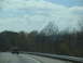 1995 Ford C-350 (Centurion Conversions) - Vehicles on a highway during daytime with trees lining the road.