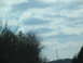 1995 Ford C-350 (Centurion Conversions) - A distant cell tower stands on a hill, silhouetted against a cloudy sky.