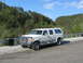1995 Ford C-350 (Centurion Conversions) - White 1995 Ford C-350 (Centurion Conversions) pickup truck with camper shell parked roadside.