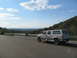 1995 Ford C-350 (Centurion Conversions) - A white 1995 Ford C-350 (Centurion Conversions) is parked on the side of a road with a scenic overlook.