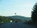 1995 Ford C-350 (Centurion Conversions) - Driving on a highway with several vehicles and a large Chevron sign visible in the distance.