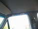 1995 Ford C-350 (Centurion Conversions) - Close-up of a vehicle's interior grab handle above the window.